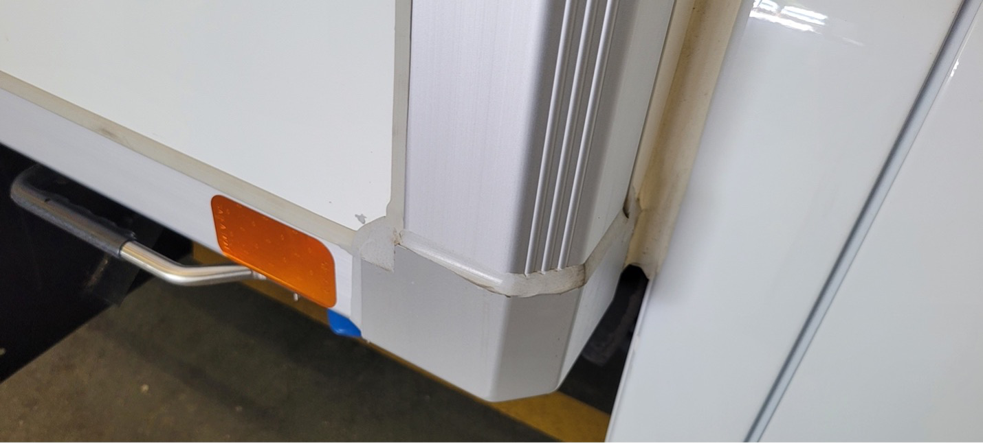 Close-up of insulated van with aluminum trim and corner seal for temperature control.