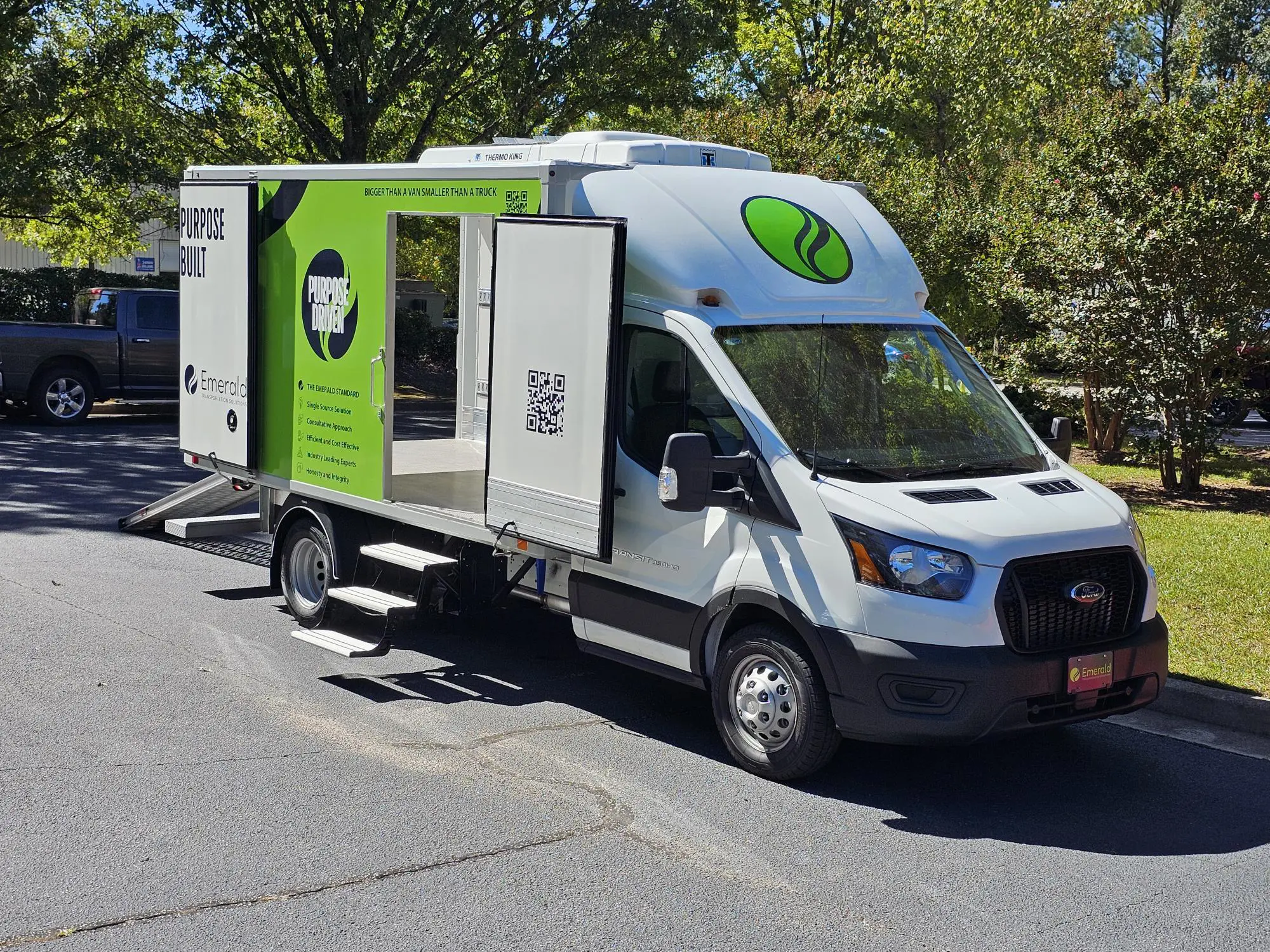 Emerald refrigerated vehicle with side door, steps, and ramp for easy product loading and unloading.