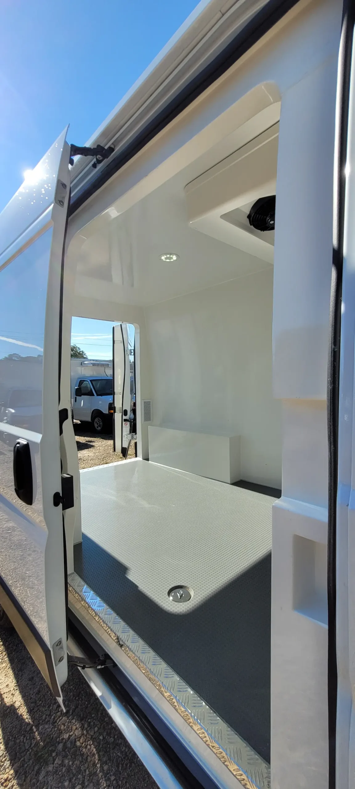 Interior view of an Emerald refrigerated van with insulated walls, ceiling, and flooring for temperature control.