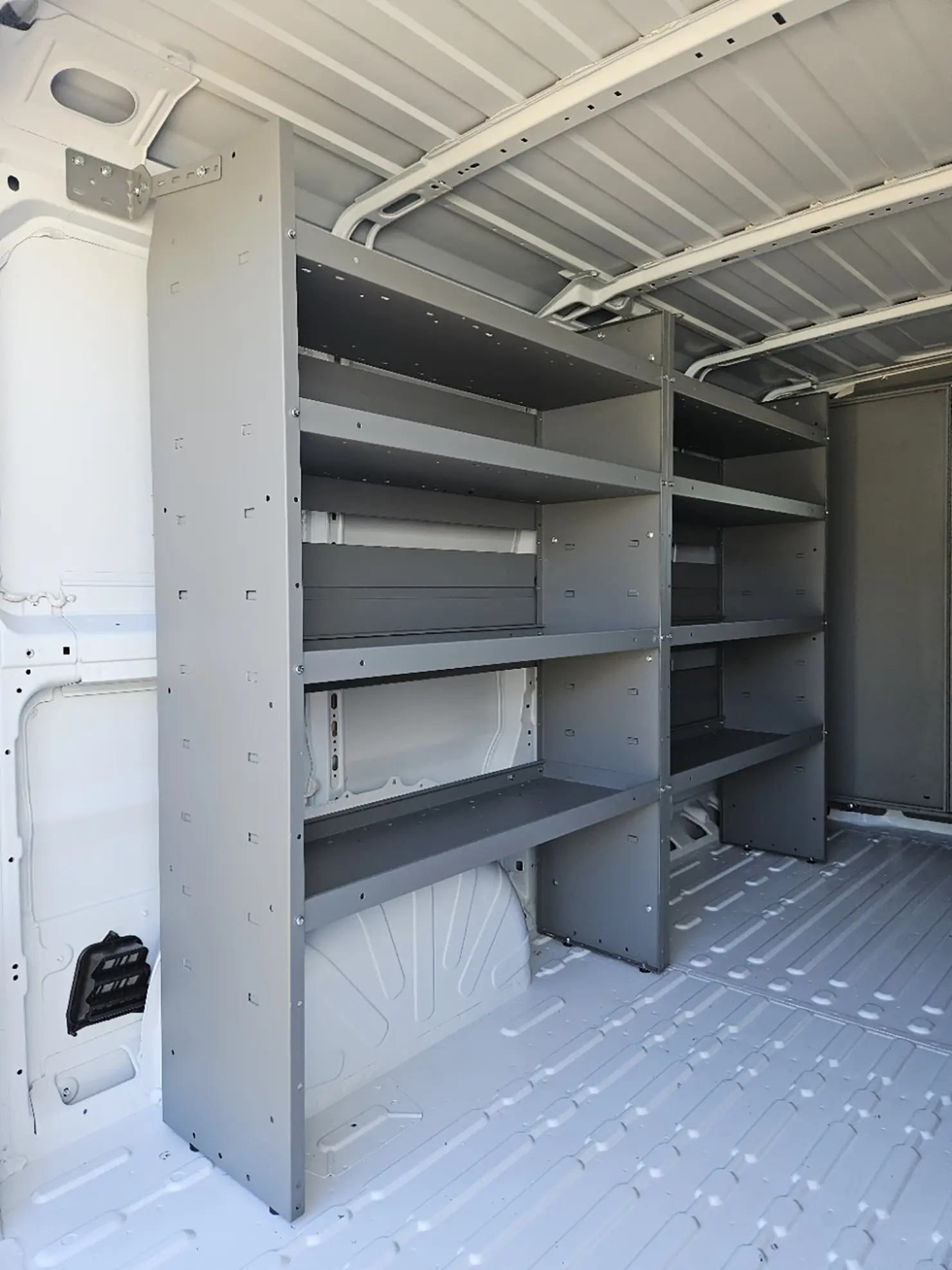 Interior of an Emerald refrigerated van with shelving, showing space that can be fitted with bulkheads, strip curtains, and cooling compartments for organized temperature control.
