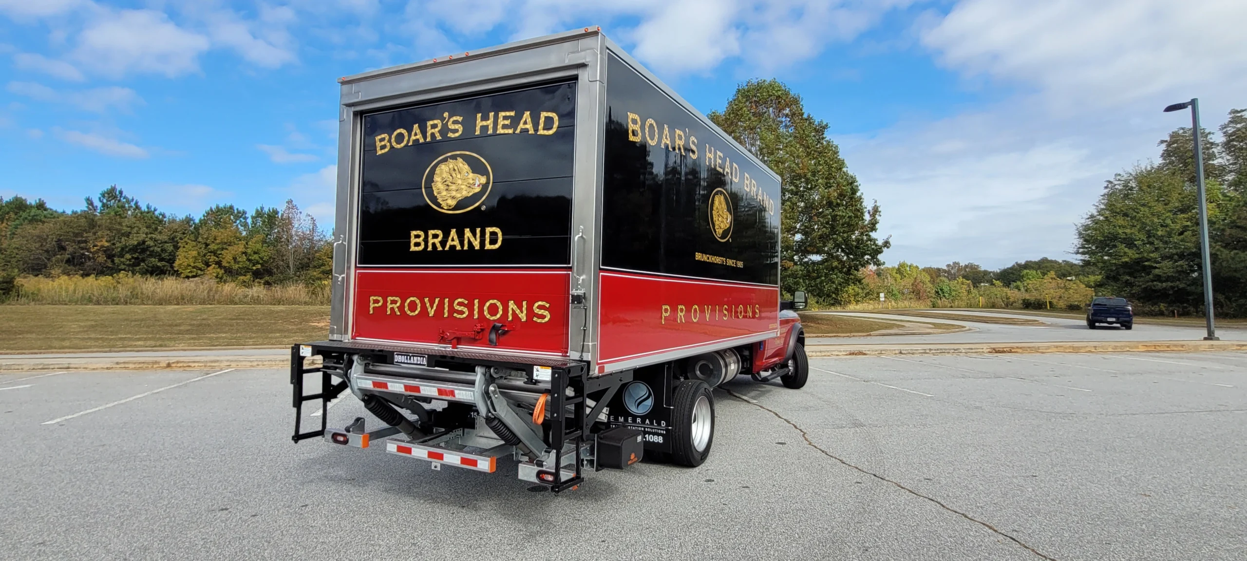 Rear view of a Boar’s Head branded Emerald refrigerated truck featuring a reinforced vendor safety bumper with integrated steps.